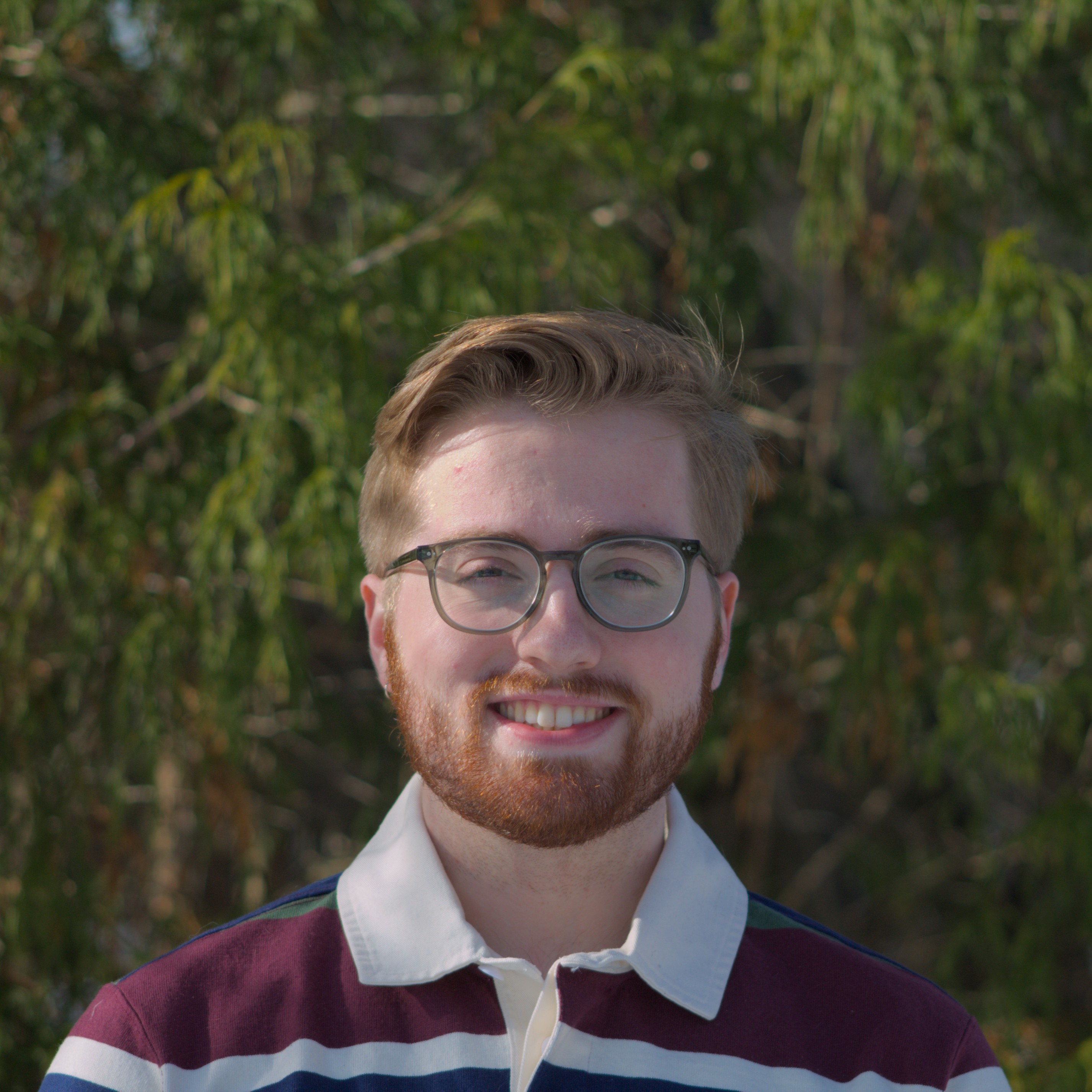 Image of Ethan Baker standing in front of a sunset
